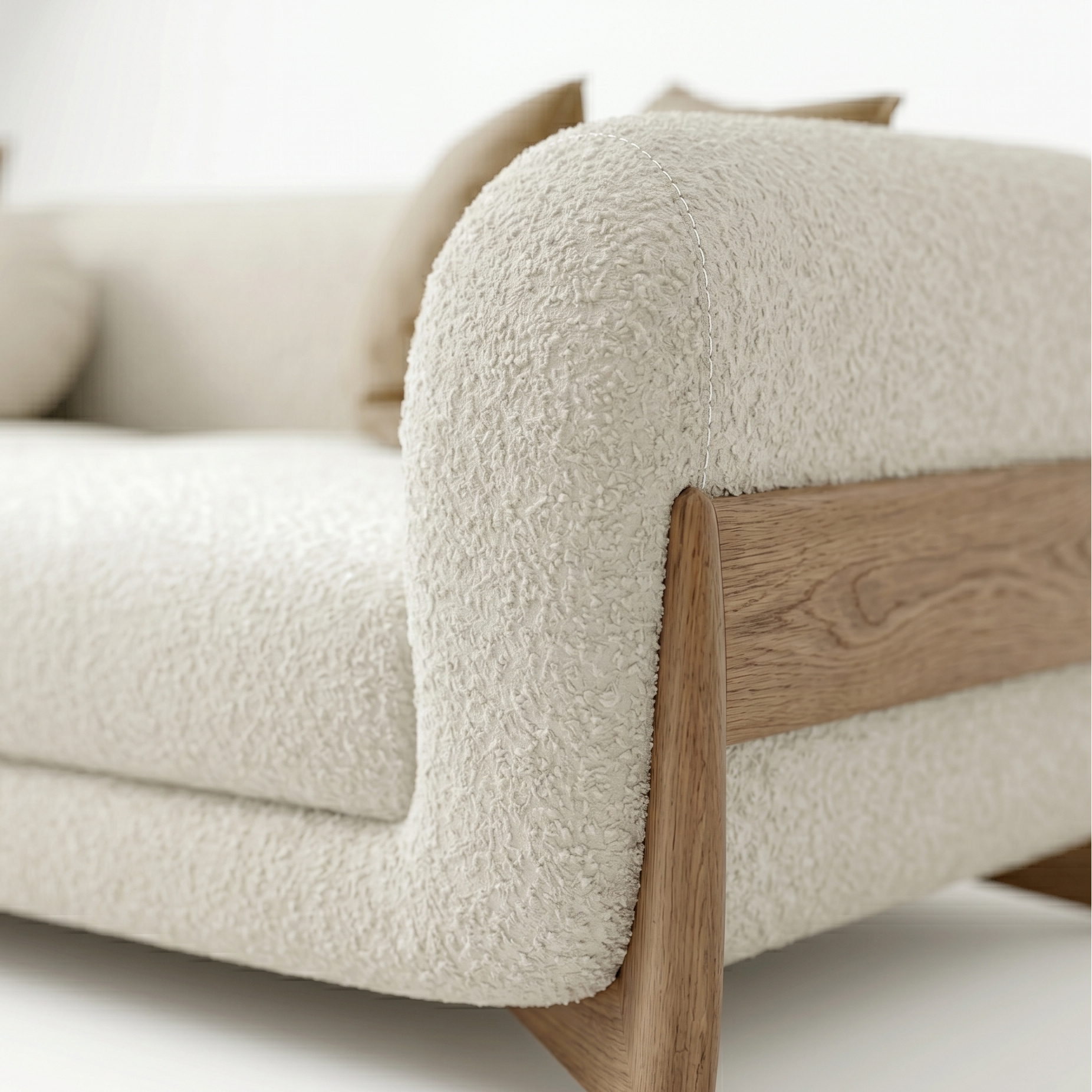 Beige sofa with wooden armrests on a white background